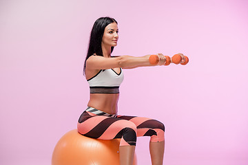 Image showing The woman training against pink studio