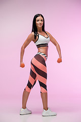 Image showing The woman training against pink studio