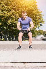 Image showing Fit man doing exercises outdoors at park