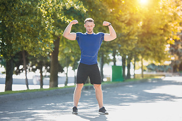 Image showing Fit man doing exercises outdoors at park