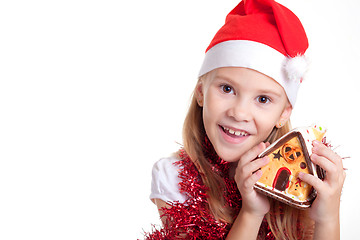 Image showing Happy little smiling girl with christmas house.