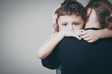 Image showing sad son hugging his mother