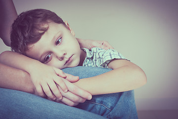 Image showing sad son hugging his mother