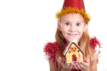 Image showing Happy little smiling girl with christmas house. 