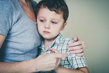 Image showing sad son hugging his mother