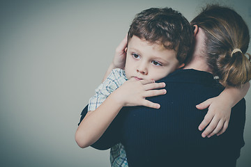 Image showing sad son hugging his mother