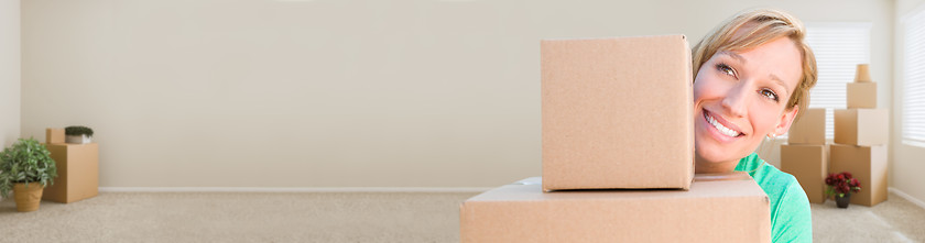 Image showing Banner of Happy Young Adult Woman Holding Moving Boxes In Empty 