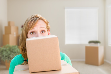 Image showing Happy Young Adult Woman Holding Moving Boxes In Empty Room In A 