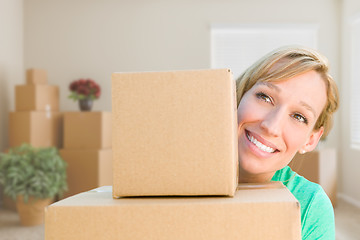 Image showing Happy Young Adult Woman Holding Moving Boxes In Empty Room In A 