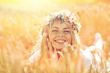 Image showing happy woman in wreath of flowers on cereal field