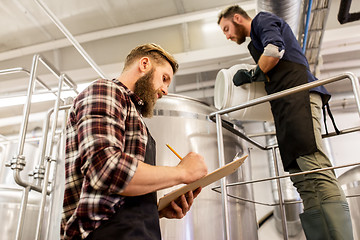 Image showing men working at craft brewery or beer plant