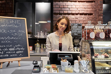 Image showing happy woman or barmaid with cashbox at cafe