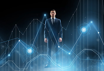 Image showing businessman in suit over black with virtual graph