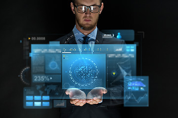 Image showing businessman with virtual screens over black