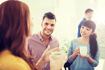 Image showing happy creative team drinking coffee at office