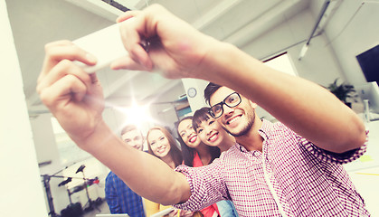 Image showing creative business team taking selfie at office