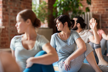 Image showing group of people doing yoga exercises at studio