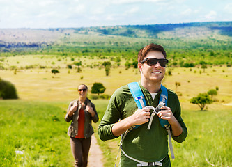 Image showing happy couple with backpacks traveling in africa