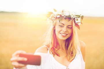 Image showing happy young woman taking selfie by smartphone