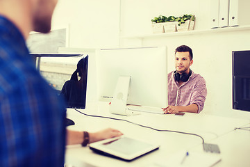 Image showing creative man with headphones and computer