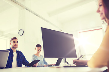 Image showing happy creative team with computers at office