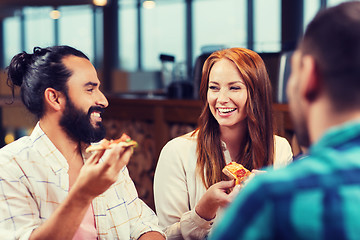 Image showing friends eating pizza with beer at restaurant