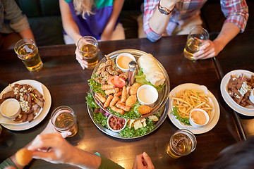 Image showing friends eating and drinking at bar or pub