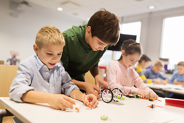 Image showing happy children building robots at robotics school