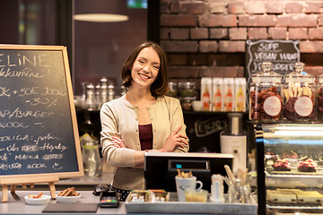 Image showing happy woman or barmaid at cafe counter