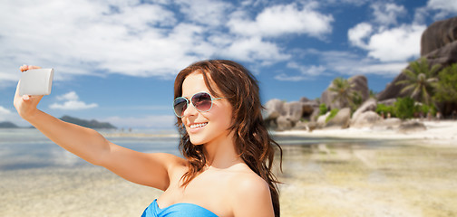 Image showing woman in swimsuit taking selfie with smatphone