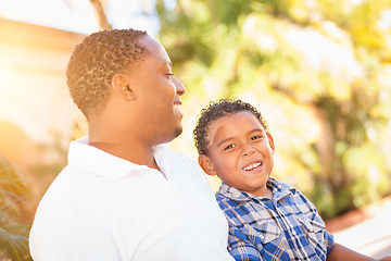 Image showing Mixed Race Son and African American Father Playing Outdoors Toge