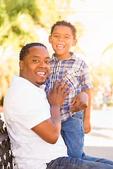 Image showing Mixed Race Son and African American Father Playing Outdoors Toge