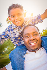 Image showing Mixed Race Son and African American Father Playing Piggyback Out