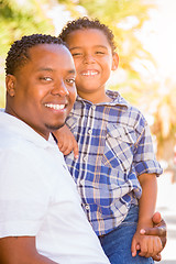 Image showing Mixed Race Son and African American Father Playing Outdoors Toge