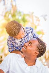 Image showing Mixed Race Son and African American Father Playing Outdoors Toge