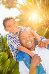 Image showing Mixed Race Son and African American Father Playing Piggyback Out