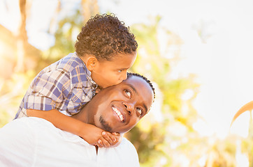 Image showing Mixed Race Son and African American Father Playing Outdoors Toge