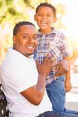 Image showing Mixed Race Son and African American Father Playing Outdoors Toge