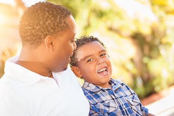 Image showing Mixed Race Son and African American Father Playing Outdoors Toge