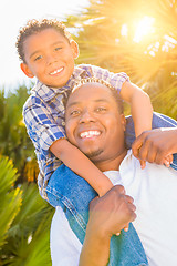 Image showing Mixed Race Son and African American Father Playing Piggyback Out