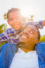 Image showing Mixed Race Son and African American Father Playing Piggyback Out