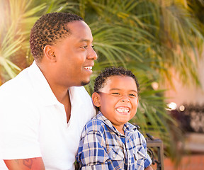 Image showing Mixed Race Son and African American Father Playing Outdoors Toge