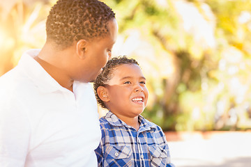 Image showing Mixed Race Son and African American Father Playing Outdoors Toge