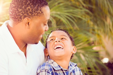 Image showing Mixed Race Son and African American Father Playing Outdoors Toge