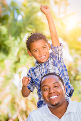 Image showing Mixed Race Son and African American Father Playing Outdoors Toge