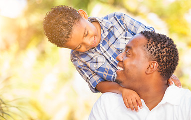 Image showing Mixed Race Son and African American Father Playing Outdoors Toge