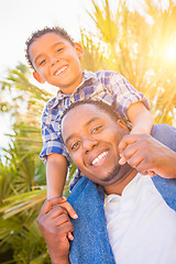 Image showing Mixed Race Son and African American Father Playing Piggyback Out