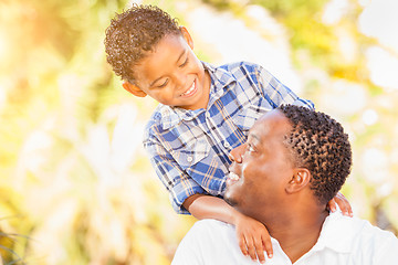 Image showing Mixed Race Son and African American Father Playing Outdoors Toge