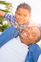 Image showing Mixed Race Son and African American Father Playing Piggyback Out