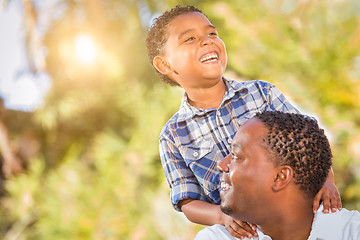 Image showing Mixed Race Son and African American Father Playing Outdoors Toge